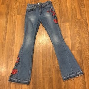 Rose embroidered flare jeans.